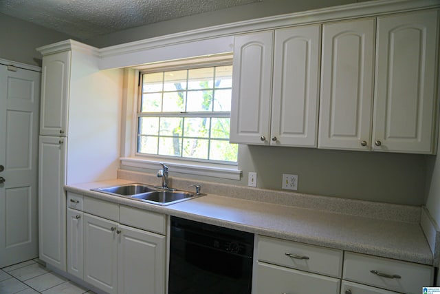 kitchen with black dishwasher, sink, light tile patterned flooring, white cabinetry, and a textured ceiling