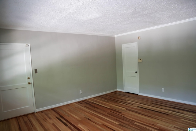 spare room featuring crown molding, a textured ceiling, and dark hardwood / wood-style flooring