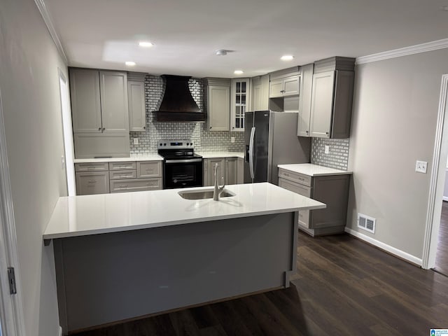 kitchen with gray cabinetry, stainless steel appliances, crown molding, custom exhaust hood, and dark hardwood / wood-style flooring