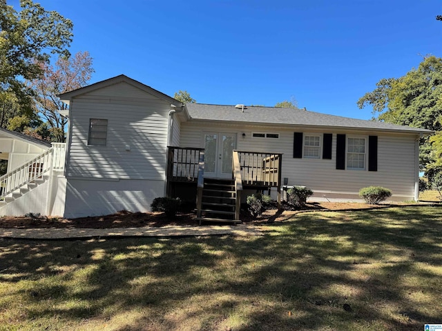 rear view of property with a yard and a wooden deck