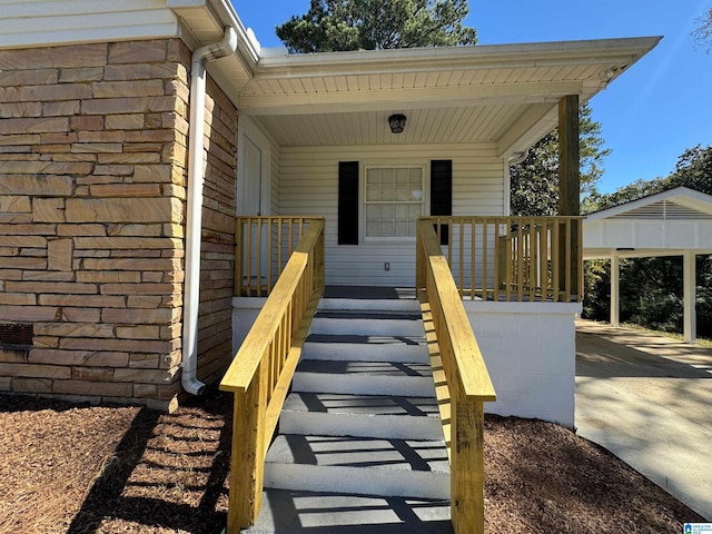 view of exterior entry featuring covered porch