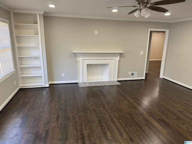 unfurnished living room with ornamental molding, dark hardwood / wood-style floors, ceiling fan, and a brick fireplace