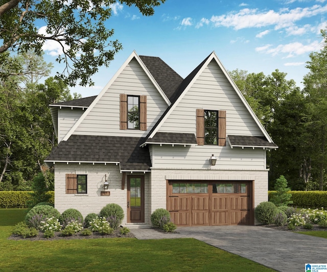 view of front of home with a front yard and a garage