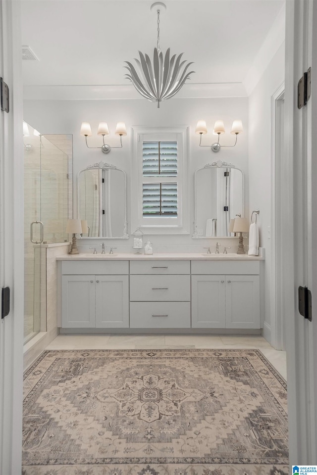 bathroom with vanity, ornamental molding, and a shower with shower door