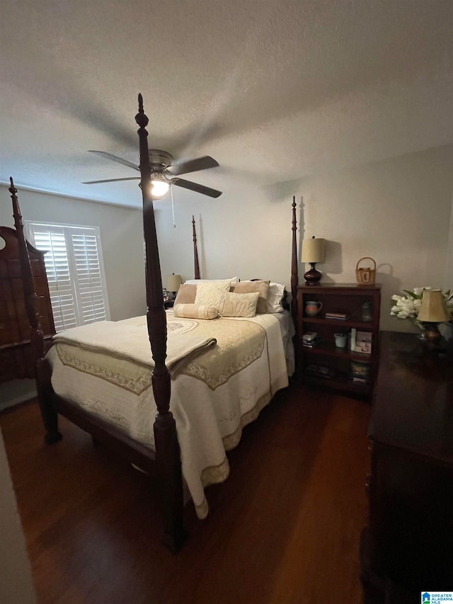 bedroom featuring a textured ceiling, ceiling fan, and dark wood-style flooring