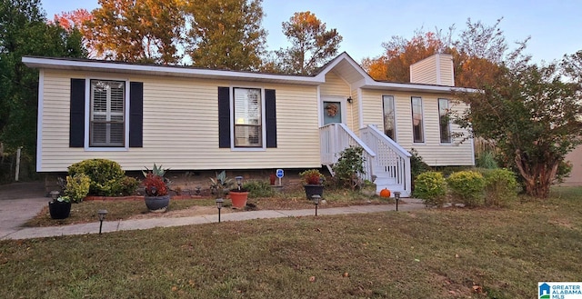 view of front facade featuring a chimney and a front yard