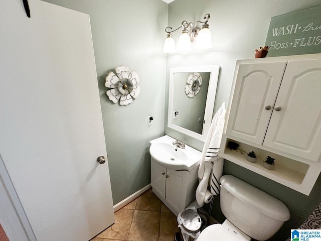 bathroom featuring tile patterned flooring, baseboards, vanity, and toilet