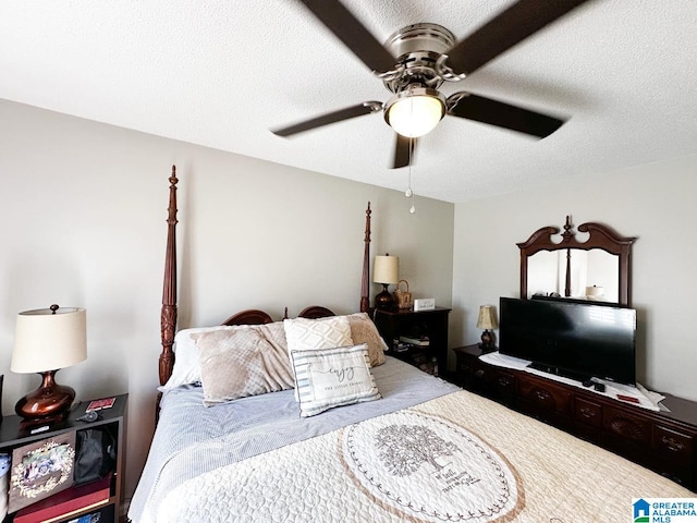 bedroom with ceiling fan and a textured ceiling