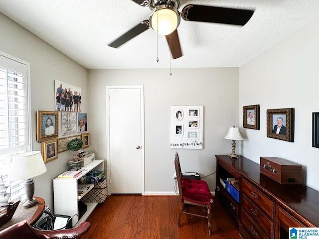 office space with ceiling fan, a textured ceiling, and wood finished floors