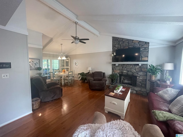 living area with lofted ceiling with beams, ceiling fan, a textured ceiling, a fireplace, and wood finished floors