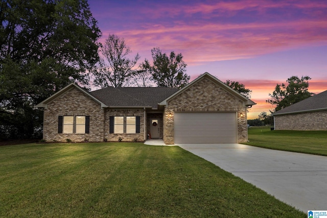 view of front of house with a yard and a garage