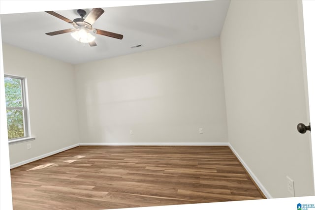 empty room featuring ceiling fan and hardwood / wood-style flooring