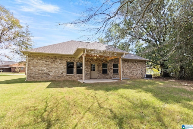 rear view of property featuring a yard, a patio area, and central AC unit