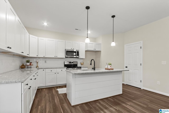 kitchen featuring hanging light fixtures, sink, white cabinetry, appliances with stainless steel finishes, and dark hardwood / wood-style flooring