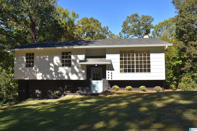 raised ranch featuring a front yard