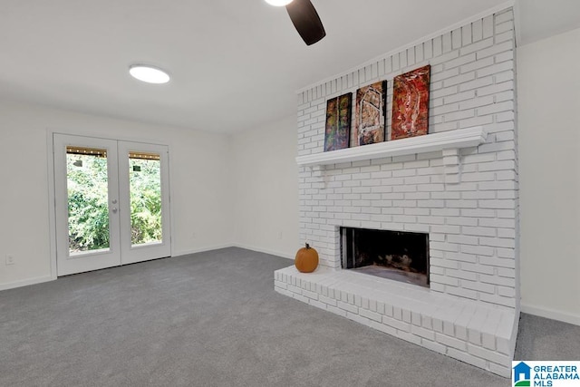 unfurnished living room featuring french doors, ceiling fan, carpet flooring, and a brick fireplace