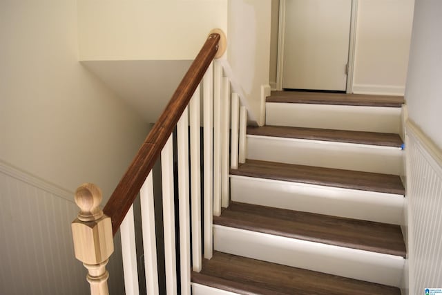 staircase with wood-type flooring