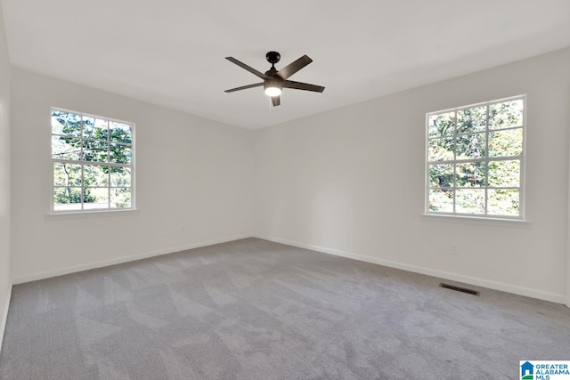 unfurnished room featuring light carpet and ceiling fan