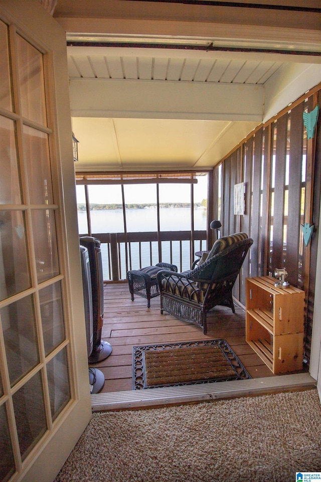 sunroom / solarium featuring beam ceiling, wood ceiling, and a water view