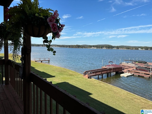 view of dock featuring a water view and a lawn