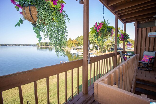 wooden deck featuring a yard and a water view