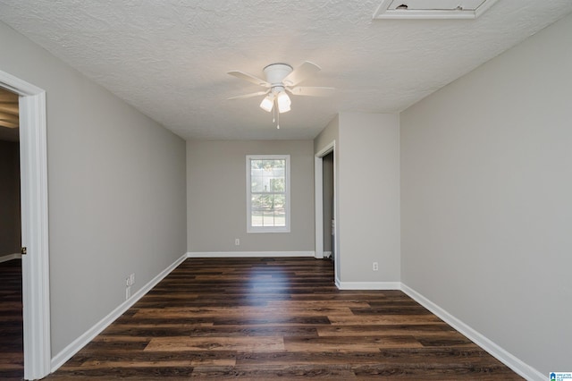 unfurnished room featuring ceiling fan, a textured ceiling, and dark hardwood / wood-style floors