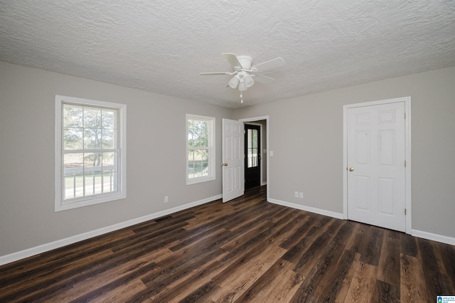 unfurnished room featuring ceiling fan, a textured ceiling, and dark hardwood / wood-style flooring