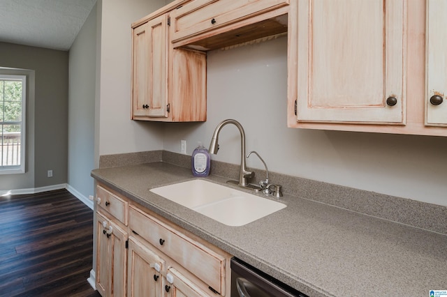 kitchen with dark wood-type flooring, sink, light brown cabinetry, and a textured ceiling