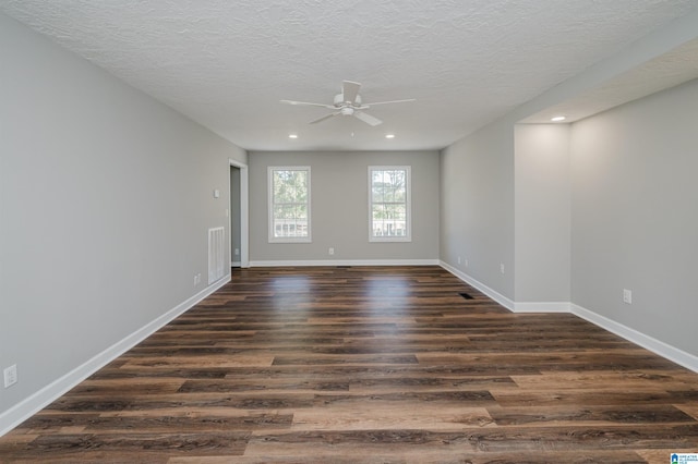 unfurnished room with a textured ceiling, ceiling fan, and dark hardwood / wood-style flooring