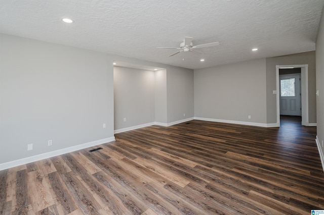 empty room featuring a textured ceiling, dark hardwood / wood-style floors, and ceiling fan