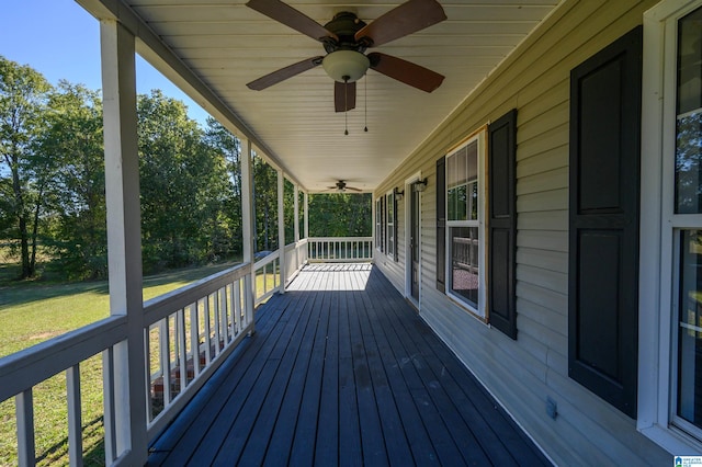 wooden terrace with a yard and ceiling fan