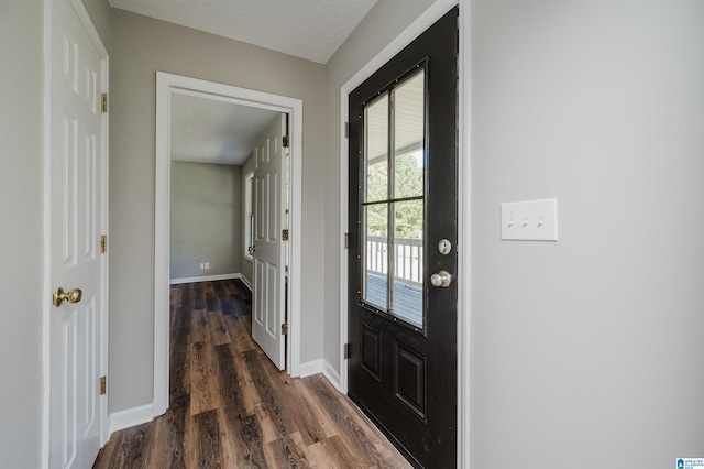 entrance foyer featuring a textured ceiling and dark hardwood / wood-style floors