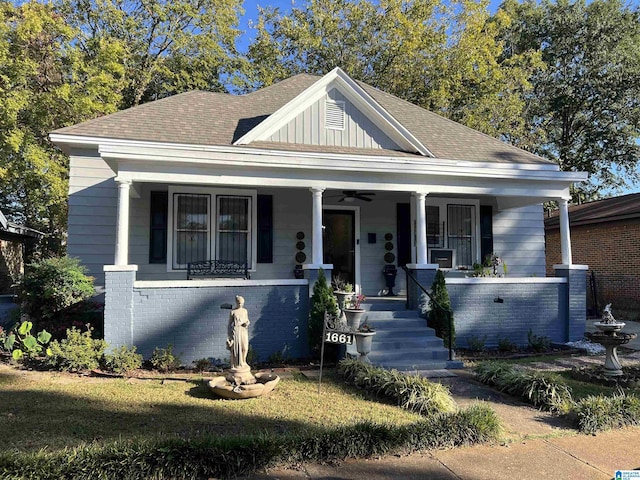 view of front of home with a porch, ceiling fan, brick siding, and roof with shingles