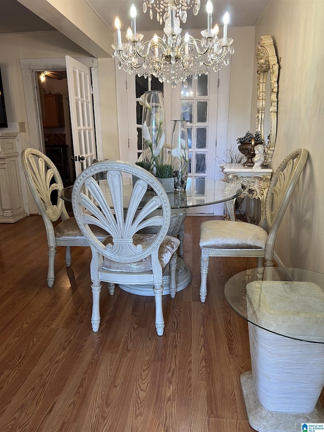 dining space with a chandelier and wood finished floors