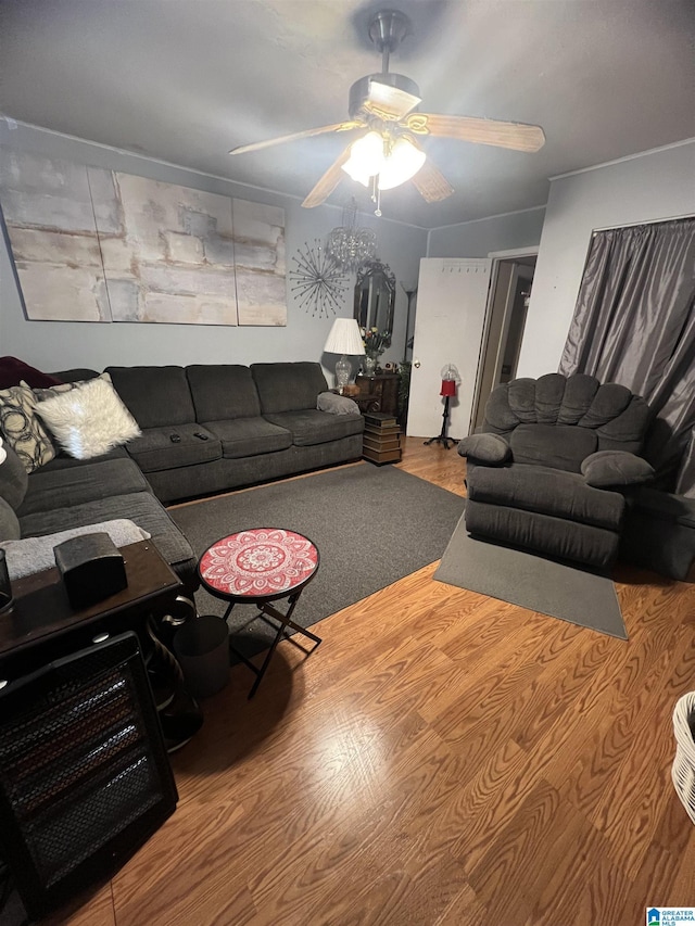 living area with a ceiling fan and wood finished floors