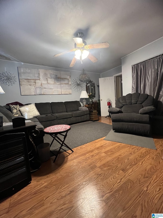 living area featuring a ceiling fan and wood finished floors