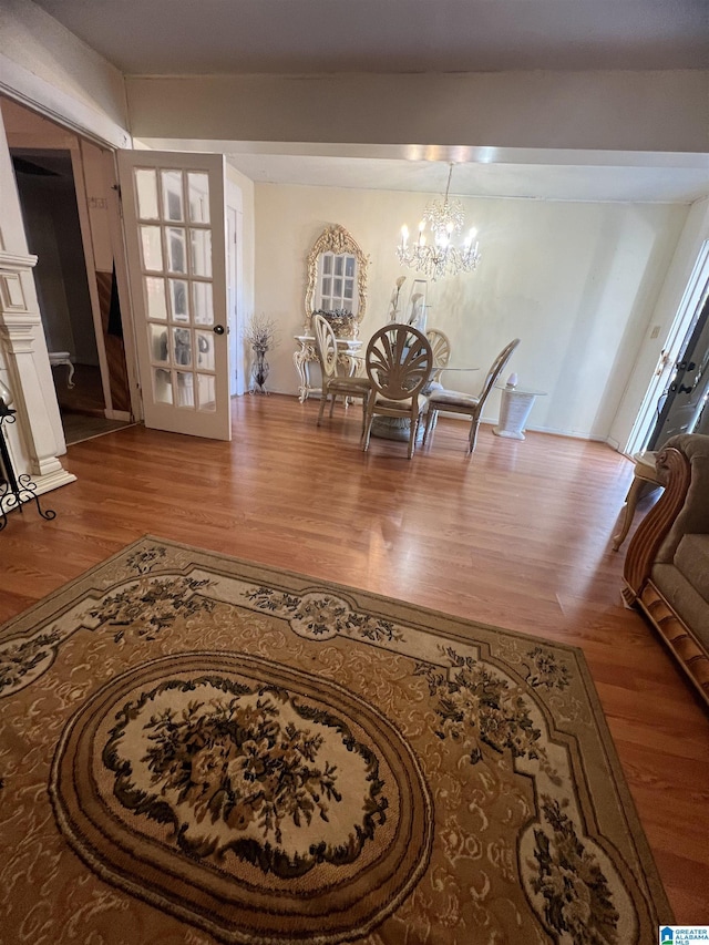 dining space with wood finished floors and a chandelier