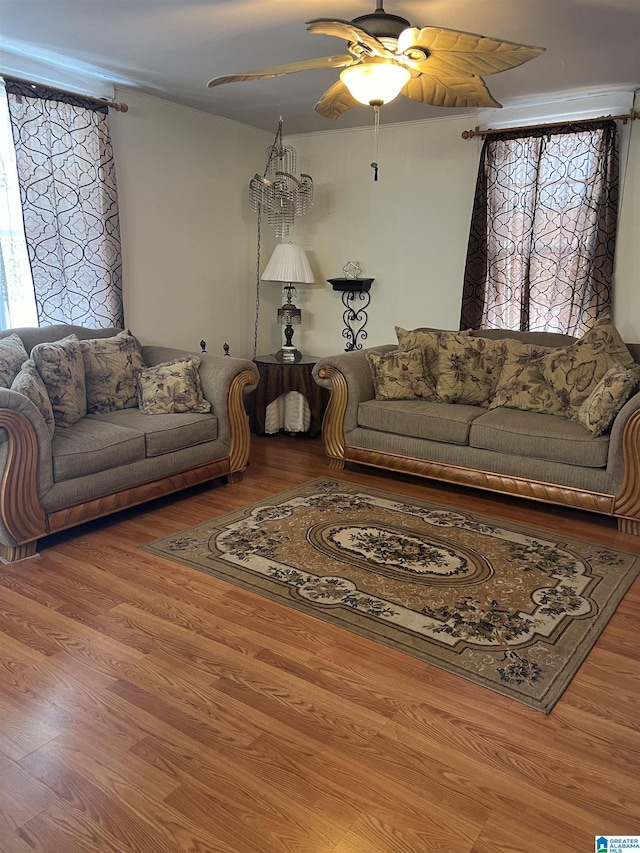 living area with wood finished floors and a ceiling fan