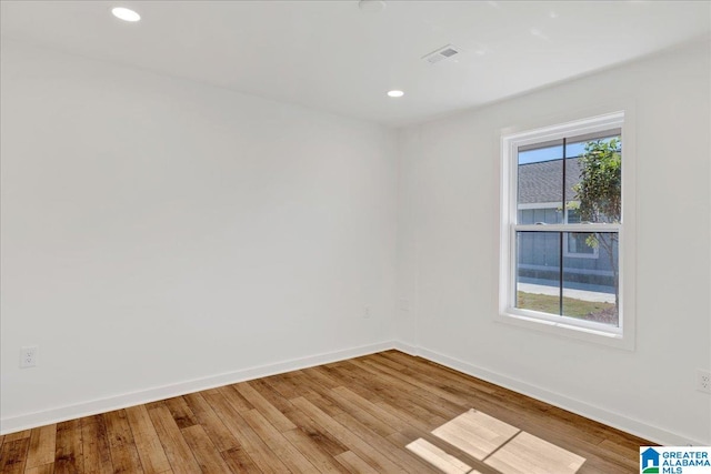 unfurnished room with hardwood / wood-style floors