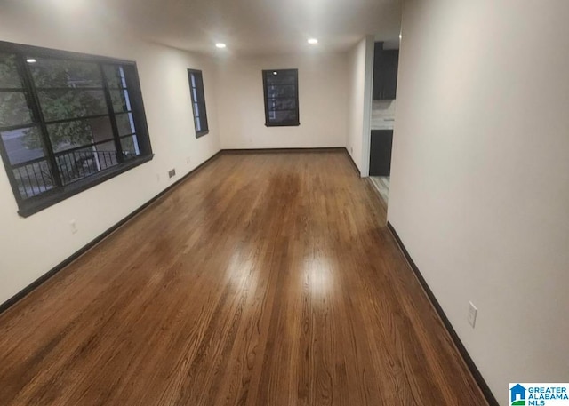 unfurnished room featuring dark wood-type flooring