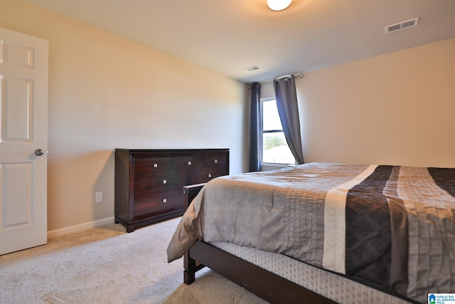 bedroom featuring light colored carpet