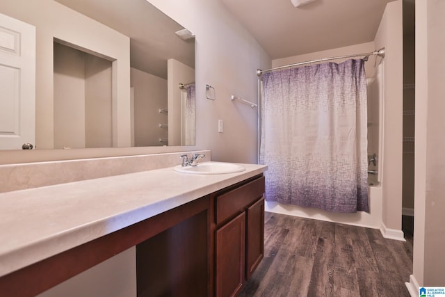 bathroom with vanity, hardwood / wood-style flooring, and shower / bath combination with curtain