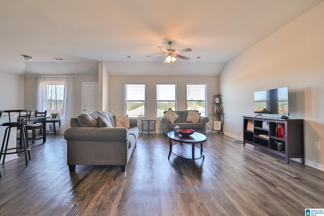 living room featuring ceiling fan, vaulted ceiling, and dark hardwood / wood-style flooring