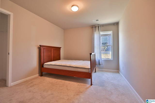 bedroom featuring light carpet