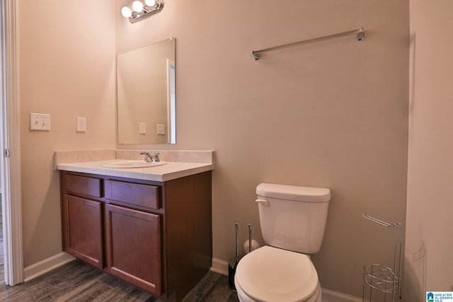 bathroom featuring vanity, wood-type flooring, and toilet