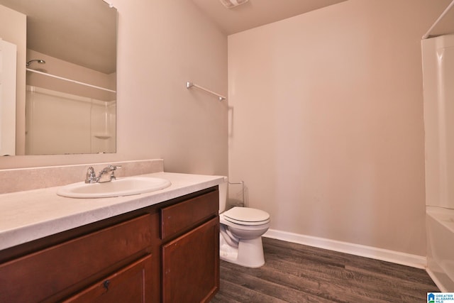 full bathroom featuring vanity, hardwood / wood-style flooring, toilet, and tub / shower combination