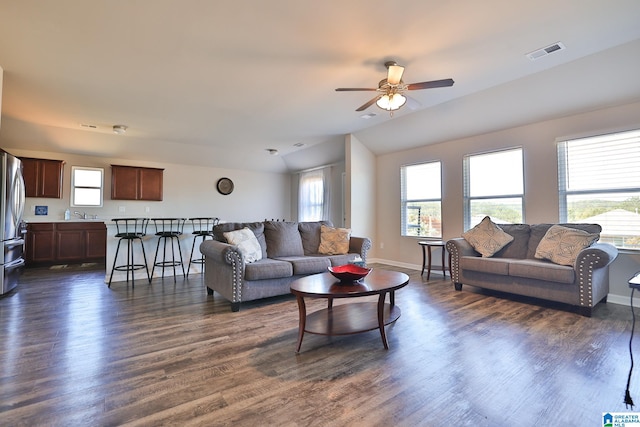 living room with dark wood-type flooring and ceiling fan