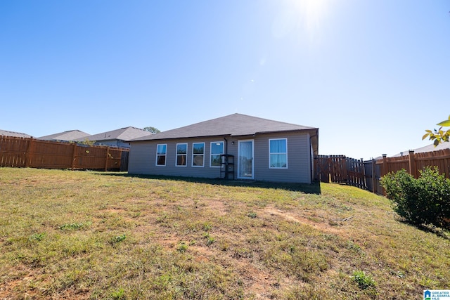 back of property featuring a lawn