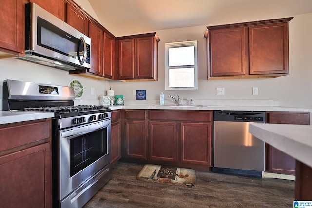 kitchen with stainless steel appliances, sink, and dark hardwood / wood-style floors