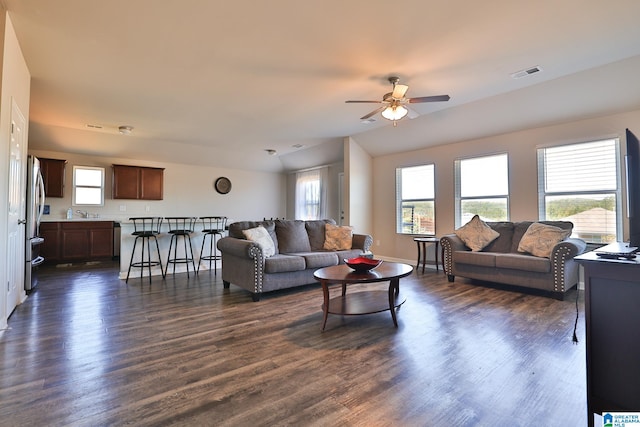 living room featuring ceiling fan and dark hardwood / wood-style flooring